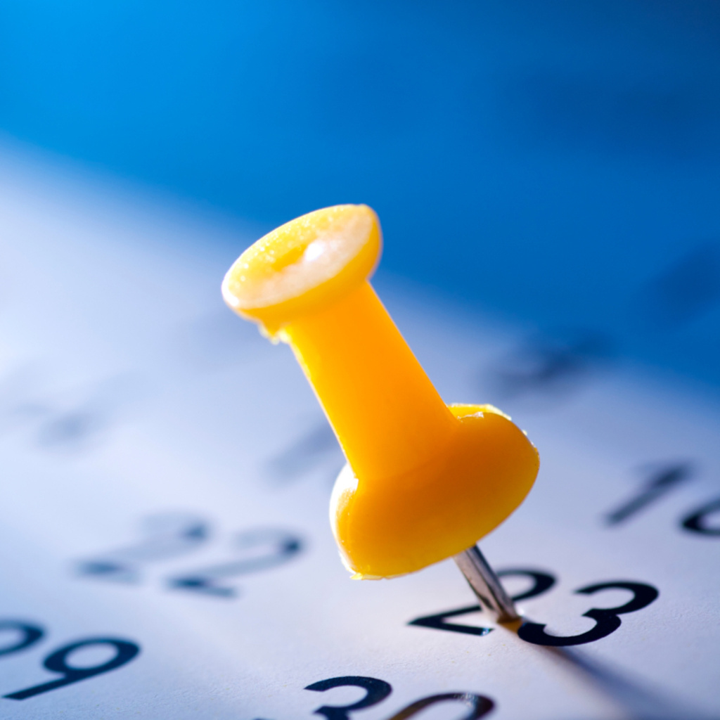 Yellow pushpin marking important date on calendar - 2026 pharmaceutical conference planning